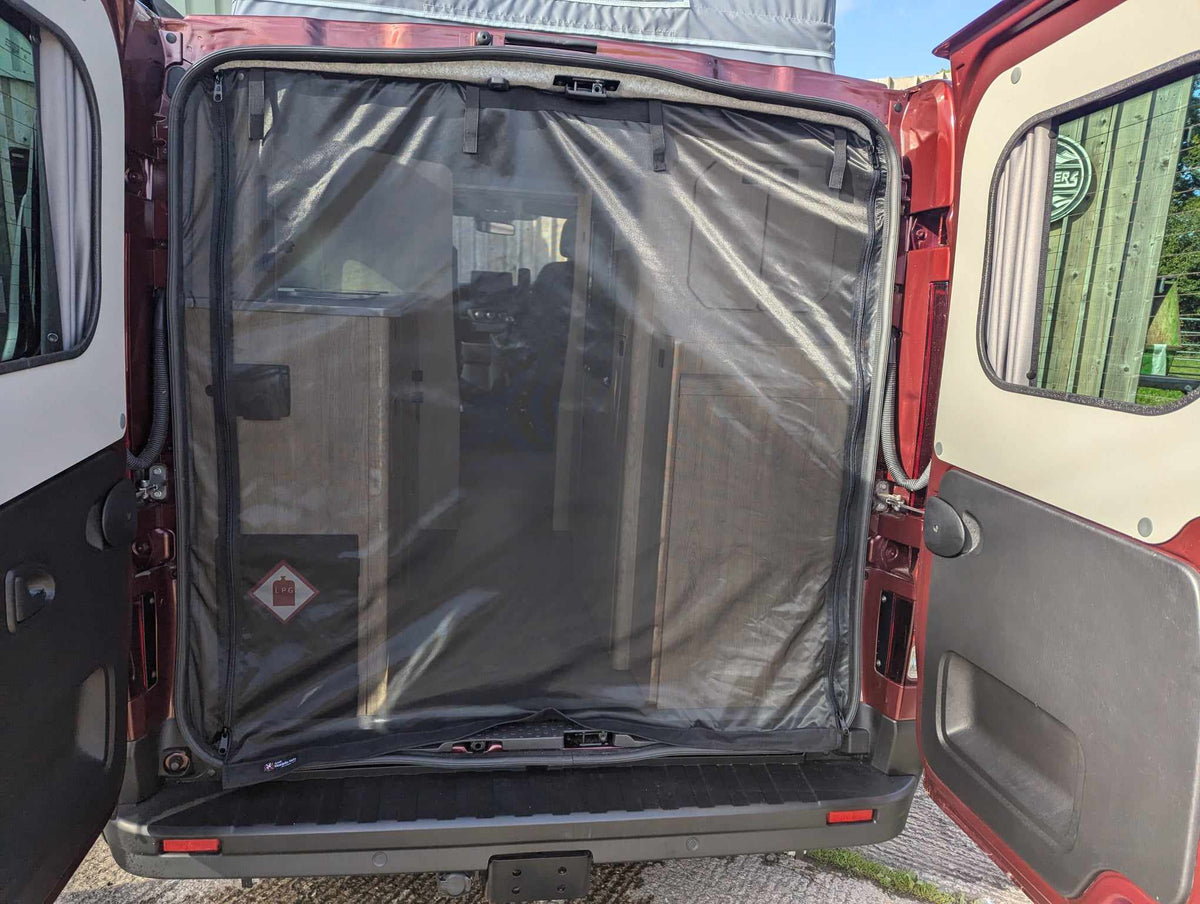 Camper van mosquito net covering open rear door, black mesh panel with elastic edge