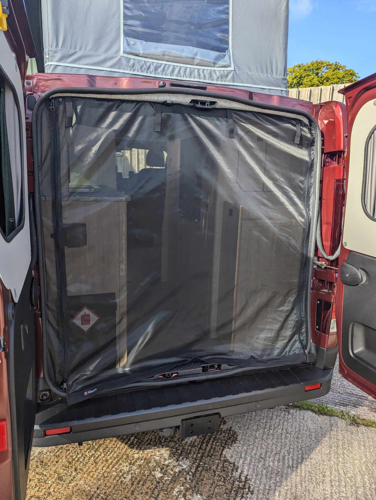 Camper van mosquito net covering rear door from outside, black mesh panel and frame