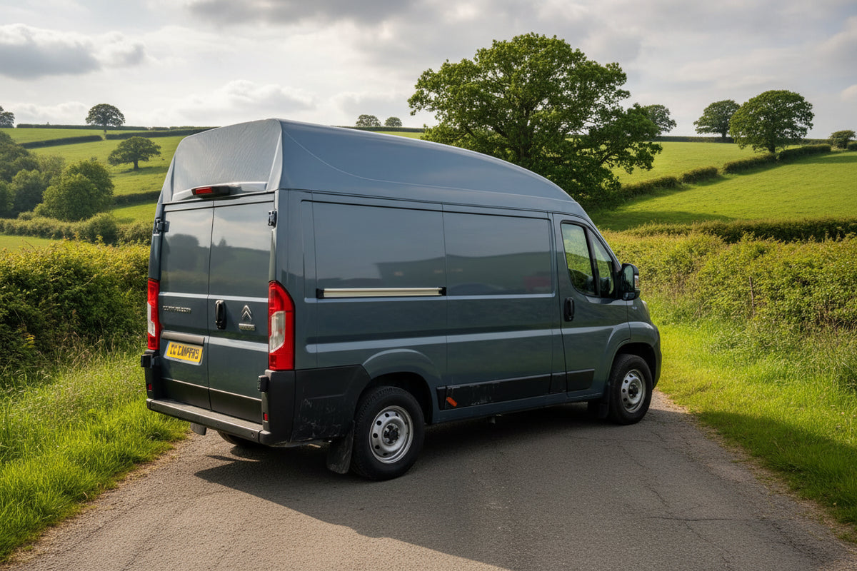 Dark blue high-top van with fixed roof fitting, rear three-quarter view