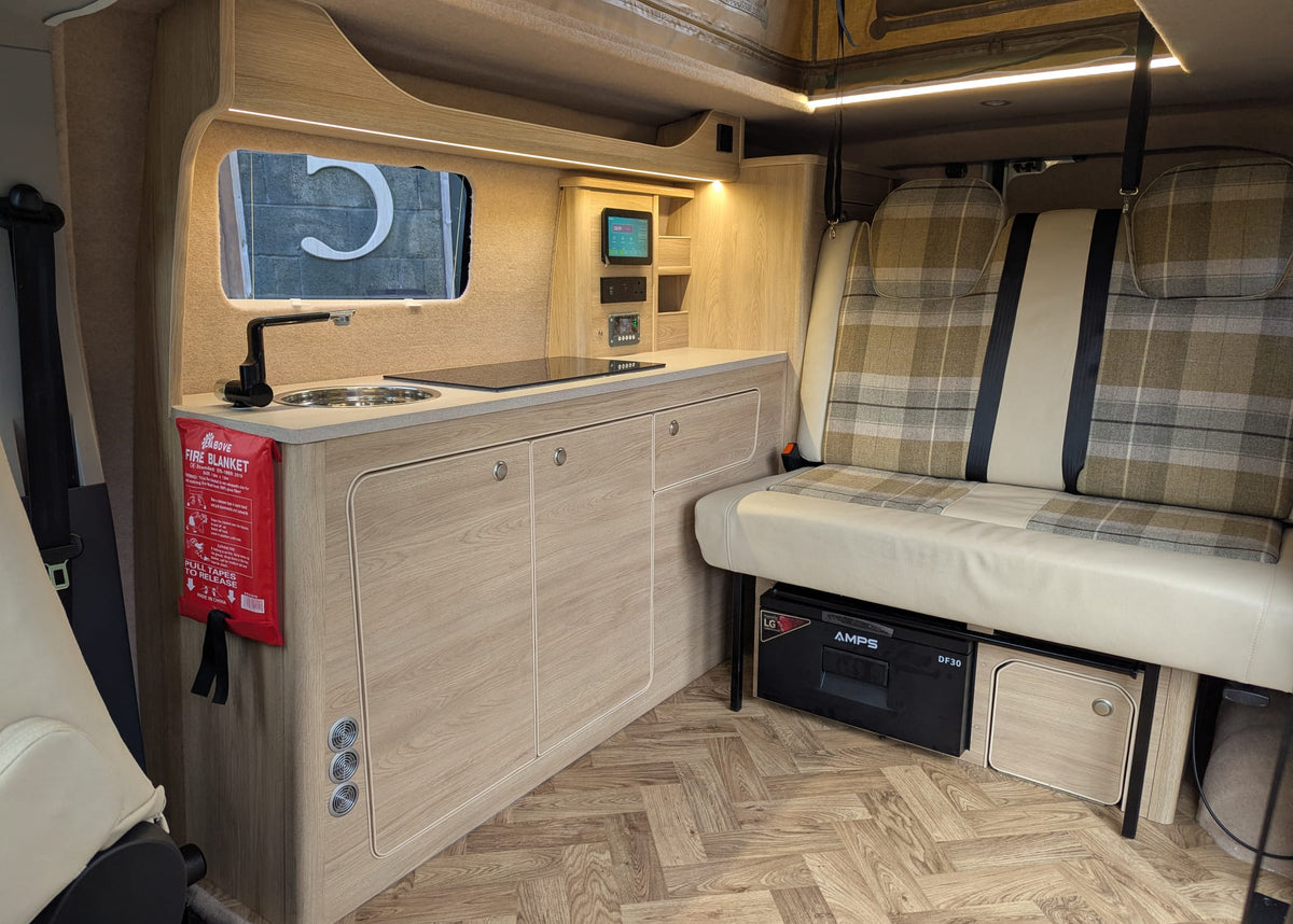 maxus edeliver 3 Micro campervan kitchen and side bench bed with striped upholstery and cabinets
