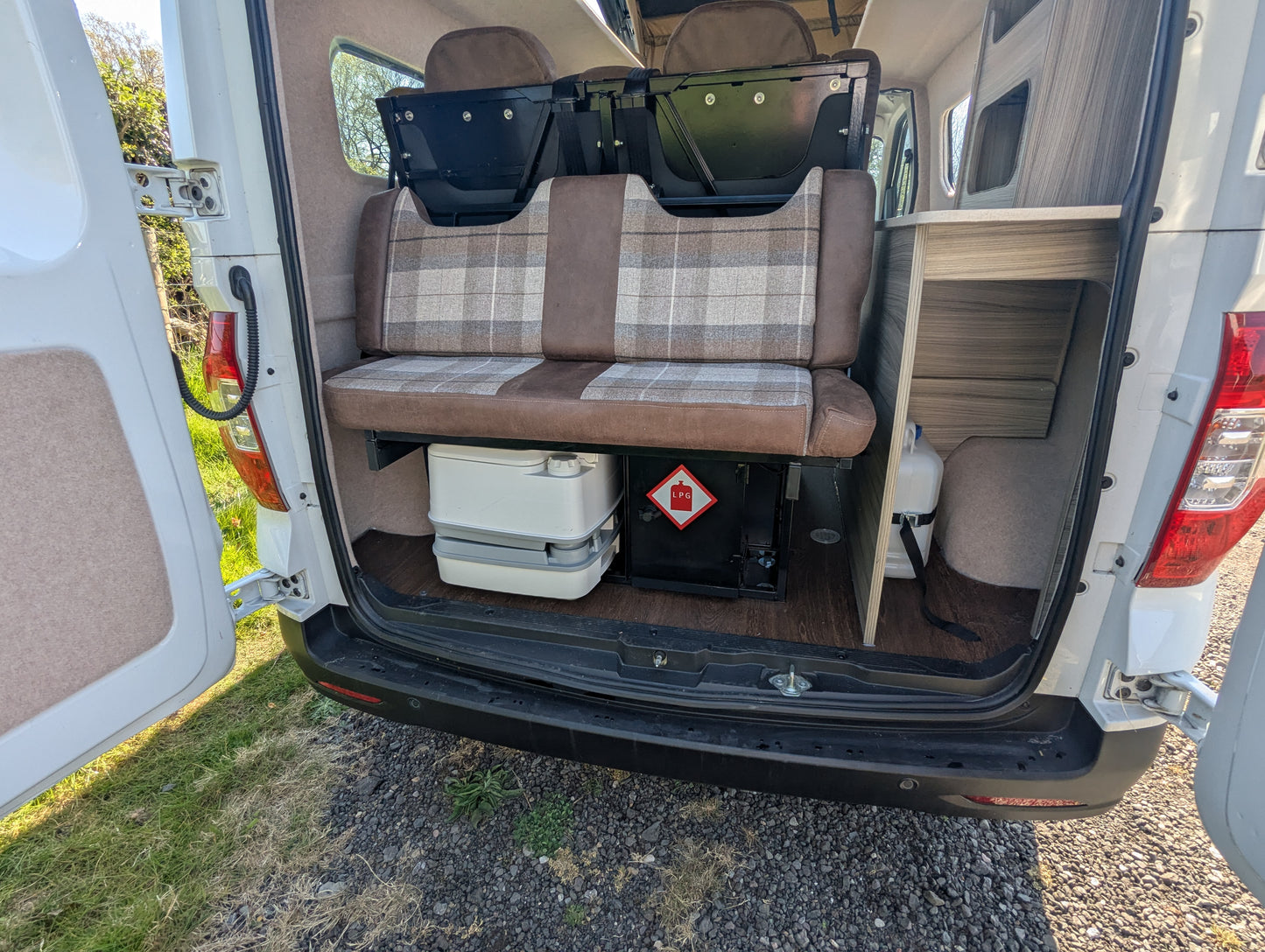 maxus edeliver 3 Electric micro campervan rear layout with bench seats and portable toilet under cabinet