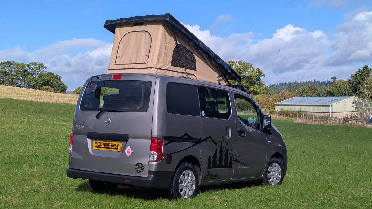 Gray pop-top micro campervan rear 3/4 view with raised canvas roof and open rear door