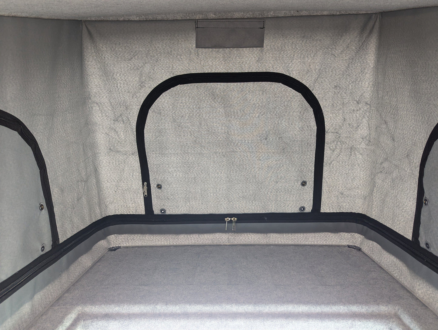 Pop-top roof interior lining with dark trim and rear window panel frame