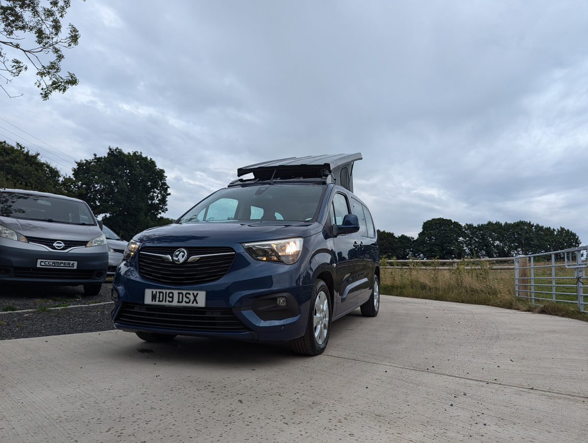 Pop-top roof panel van, blue front view with roof raised