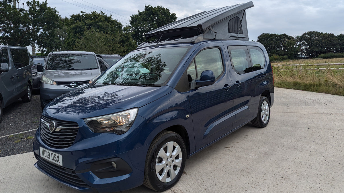 Pop-top roof panel van, blue side front view with roof raised