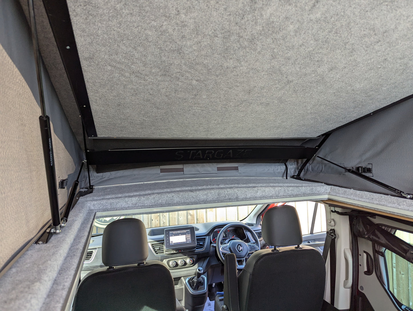 Roof bed panel open, showing support rails over car interior