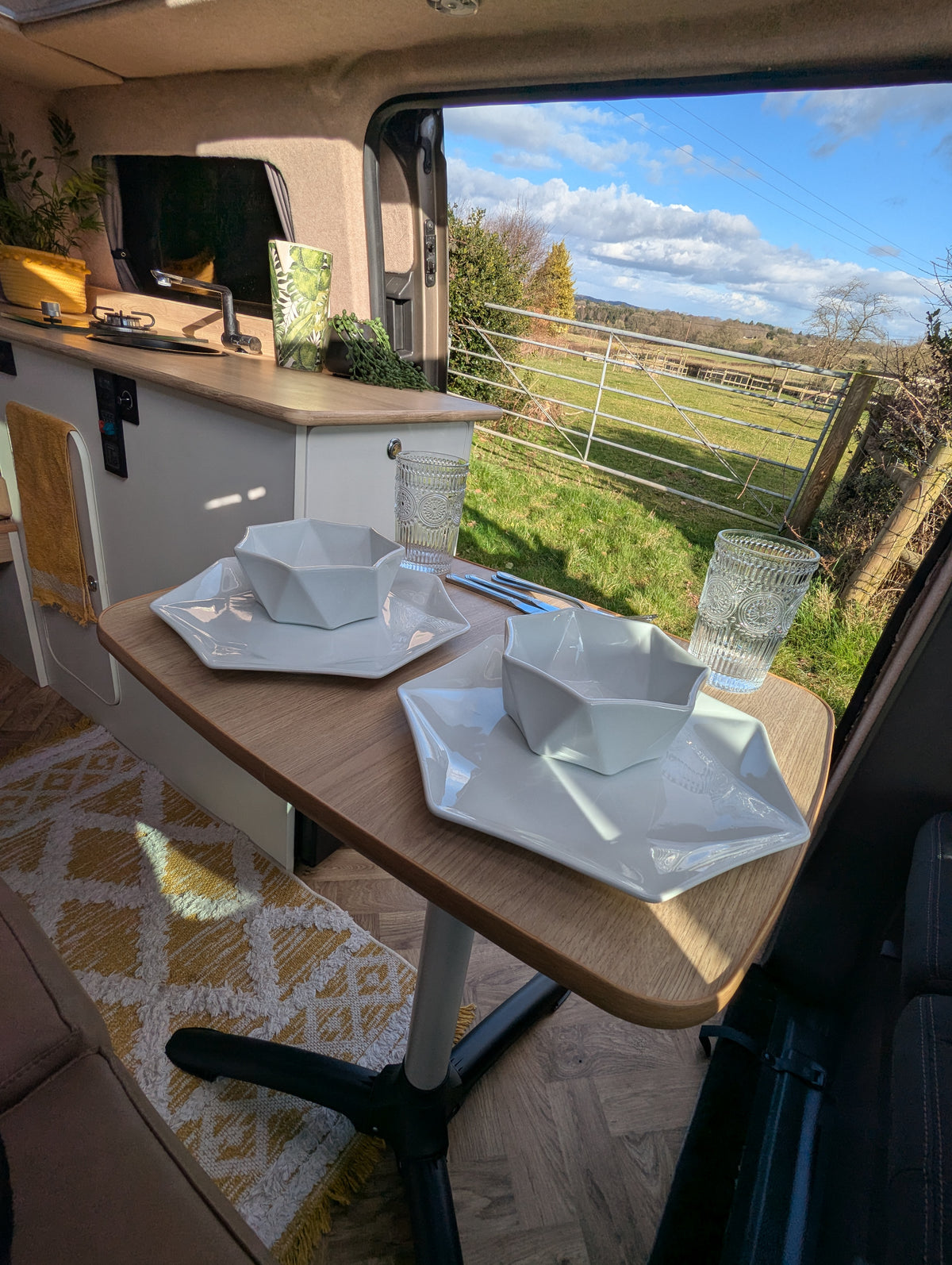 Camper van outdoor dining setup with folding table and molded serving bowls