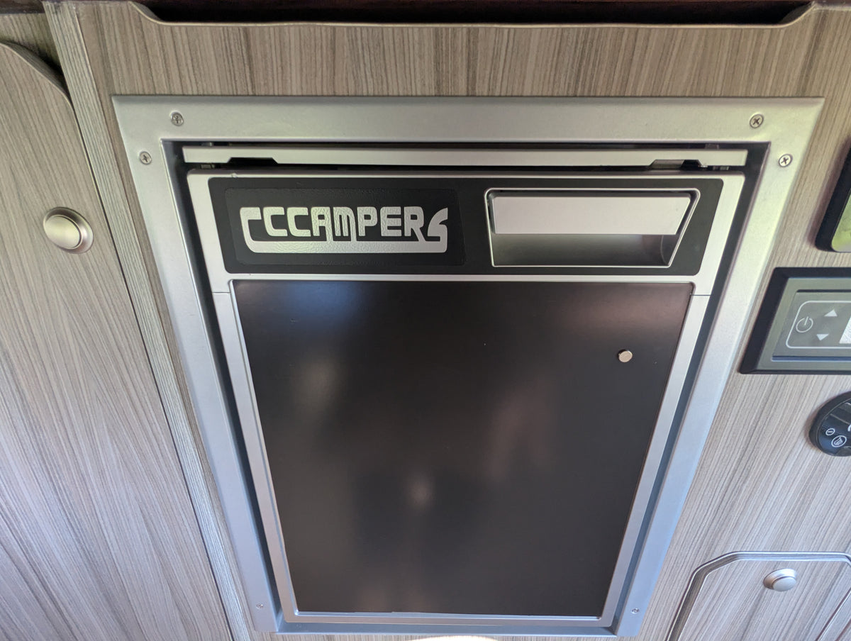 CCCampers built-in control panel with display screen set in wood trim