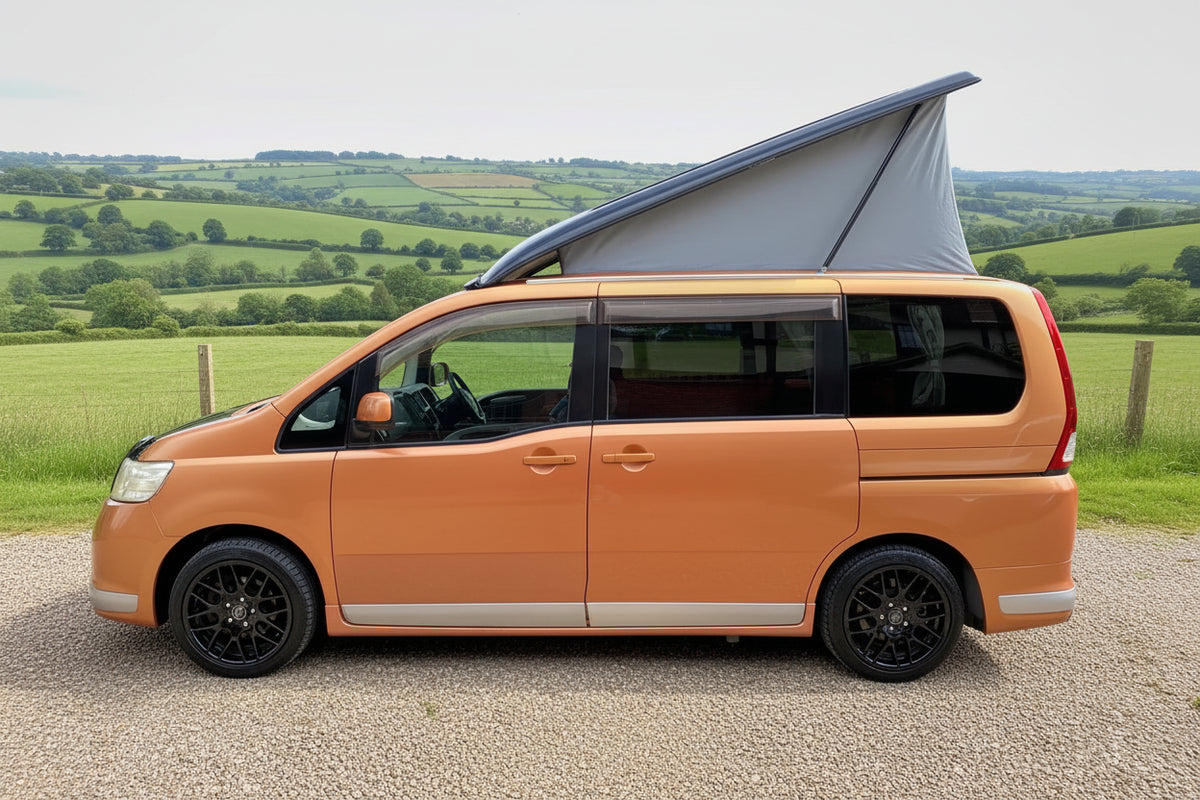 Pop-top roof for Nissan Serena camper van, raised grey canvas on orange van