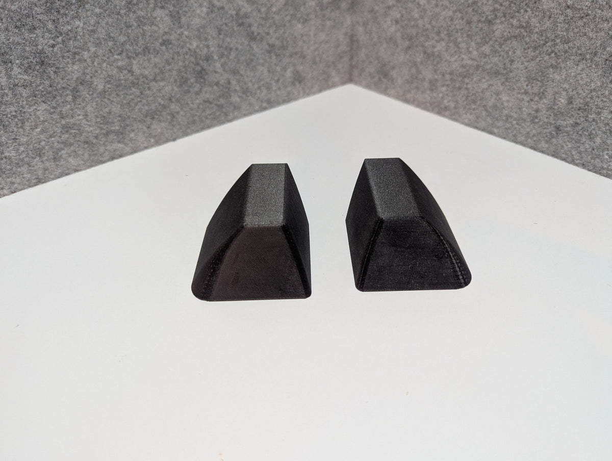 Pair of black roof rack end caps with textured grip finish