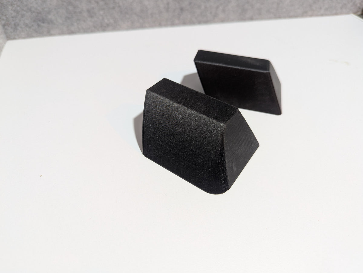 Set of 2 black roof rack replacement end caps, angular stepped shape