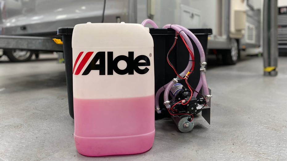 Alde coolant replacement jugs with connected heating unit, purple liquid