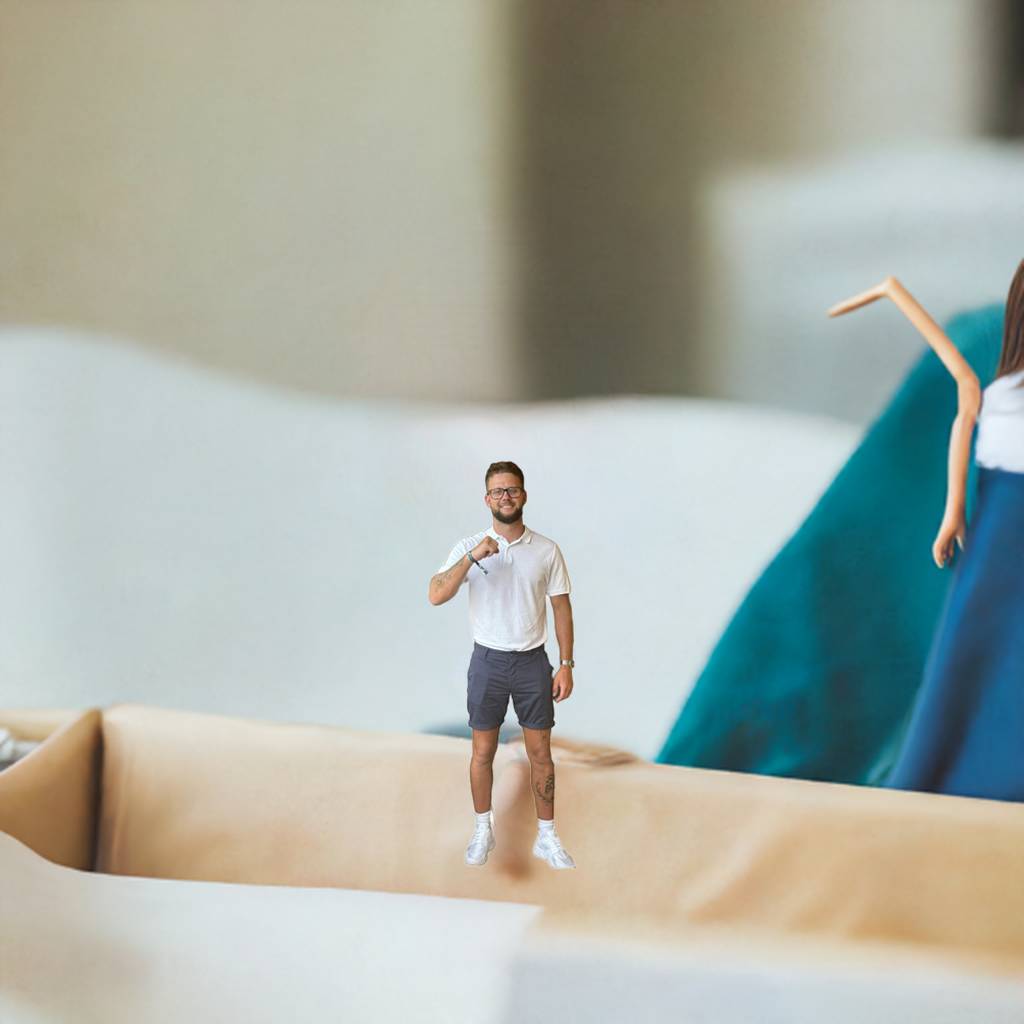 Mini companion doll standing upright, wearing white shirt and dark shorts with sneakers