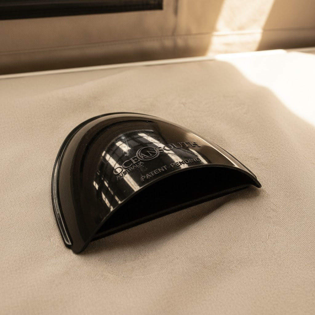 Black curved vent cover with dark mesh opening
