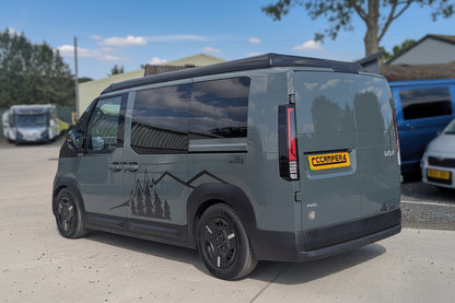 Side-rear view of dark green Kia van camper with pop-top roof closed