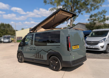 Pop-top roof raised on dark green Kia van with rear corner and open roof detail