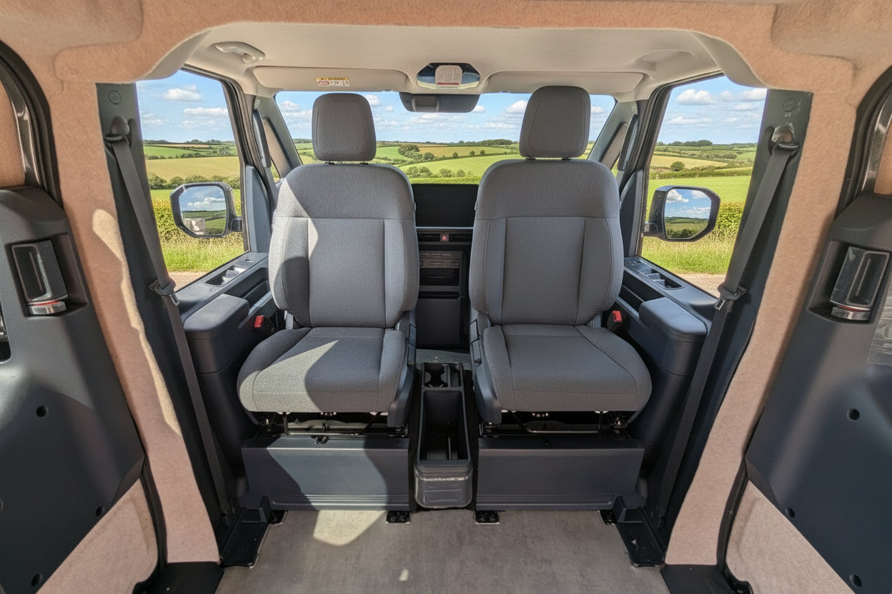 Kia PV5 dual swivel seats — driver and passenger — professionally fitted by CCCampers, M1 Tested & Certified, with lowered centre console