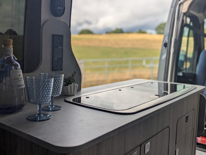 Cooking area inside a vehicle with a view of a field outside