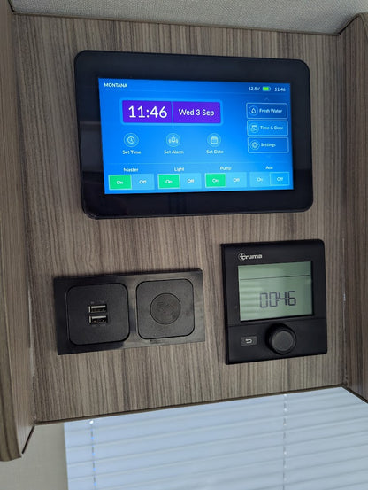 Digital display and control panel on a wooden wall