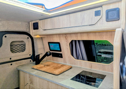 Overhead view of the upper kitchen cabinets, integrated digital system controls, and worktop appliances inside the Kia PV5 Witley campervan conversion.