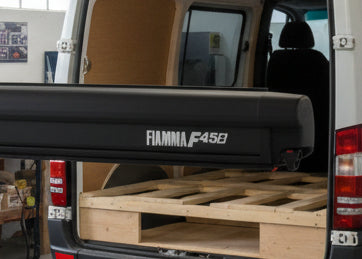 Fiamma F45S wall-mounted box awning in Deep Black case with Royal Grey canopy, professionally fitted by CCCampers