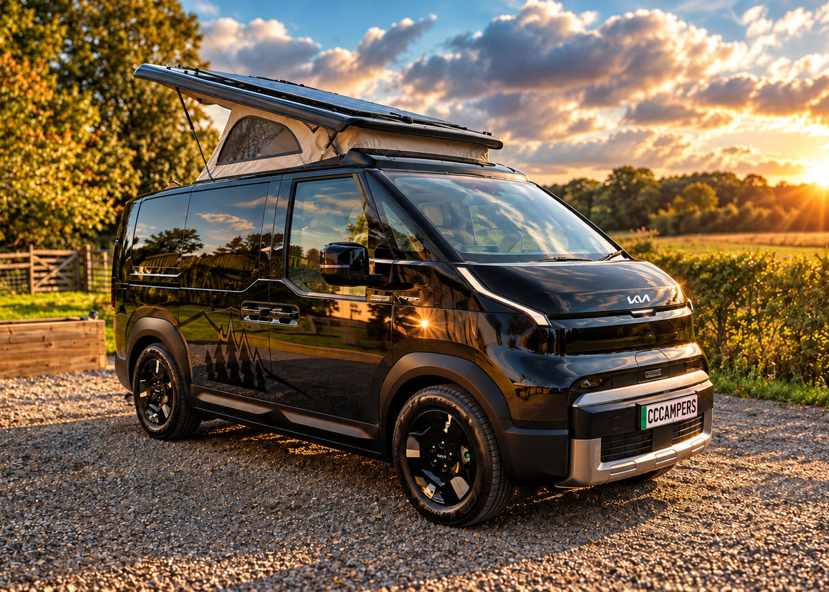 Front three-quarter exterior profile of the all-electric Kia PV5 black Witley campervan conversion parked outdoors with its pop-top roof open deployed.